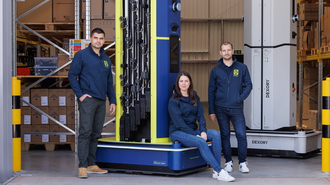 Dexory Team Sitting on Robot